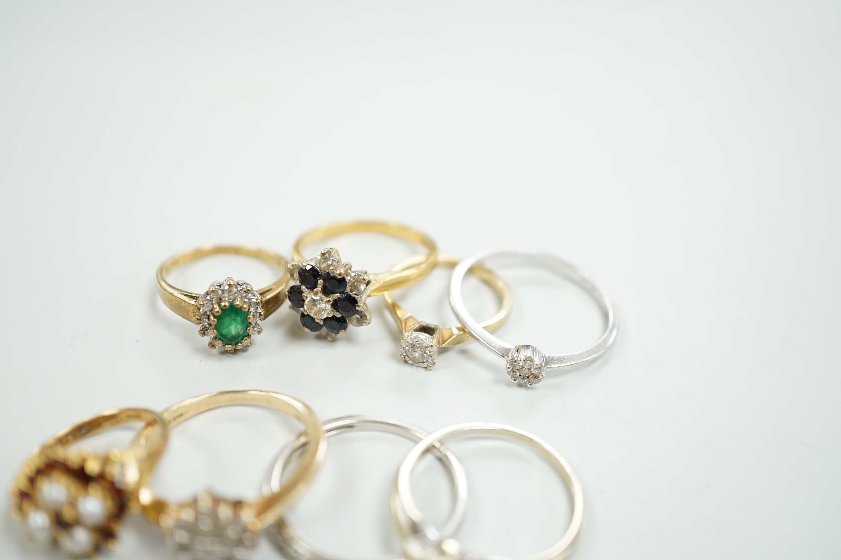 Eight assorted mainly modern 9ct gold and gem set rings, including solitaire diamond and diamond chip half eternity, gross weight 18.8 grams.
